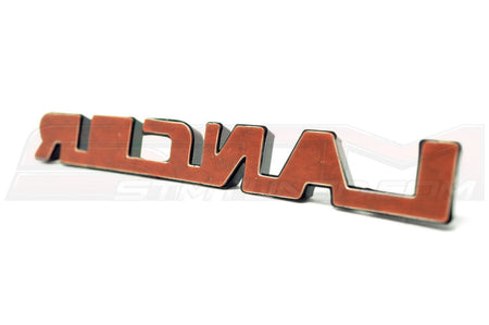 Mitsubishi OEM Evo 9 JDM Black Lancer Badge (7415A008) Image © STM Tuned Inc