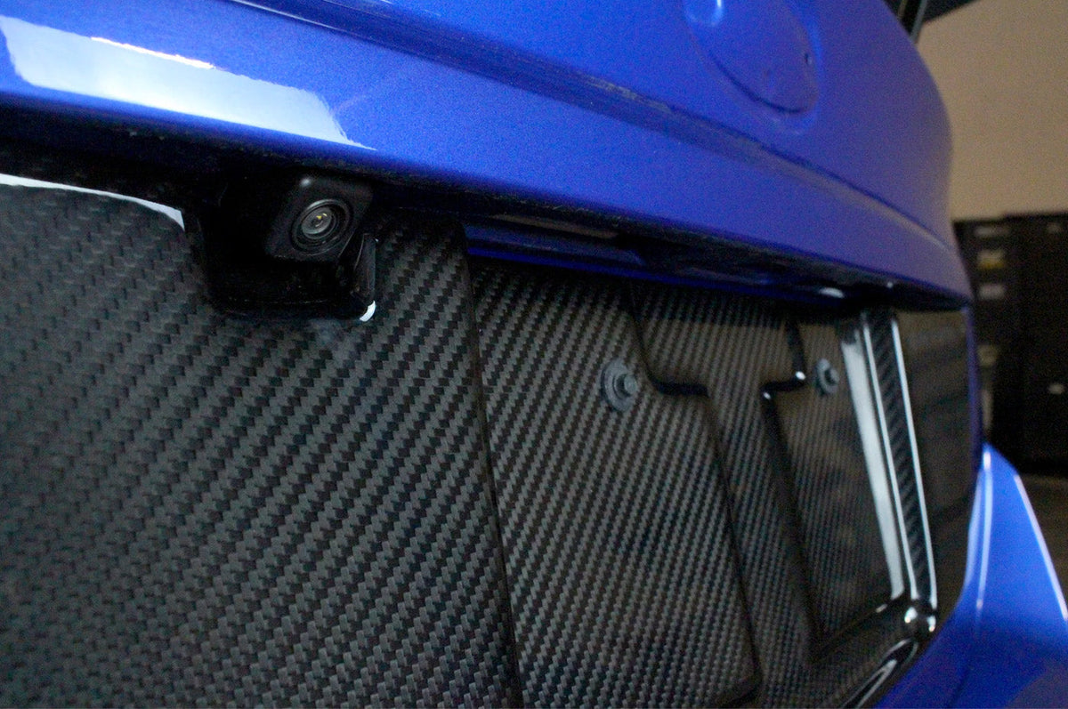 APR Carbon Fiber License Plate Frame for 2015-2021 WRX/ STi (CBX-WRXLIC15) installed upclose view