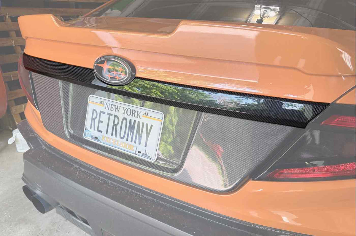 Rexpeed Dry Carbon Fiber Trunk Garnish for VB 2022+ Subaru WRX (G106) installed on Solar Orange WRX trunk
