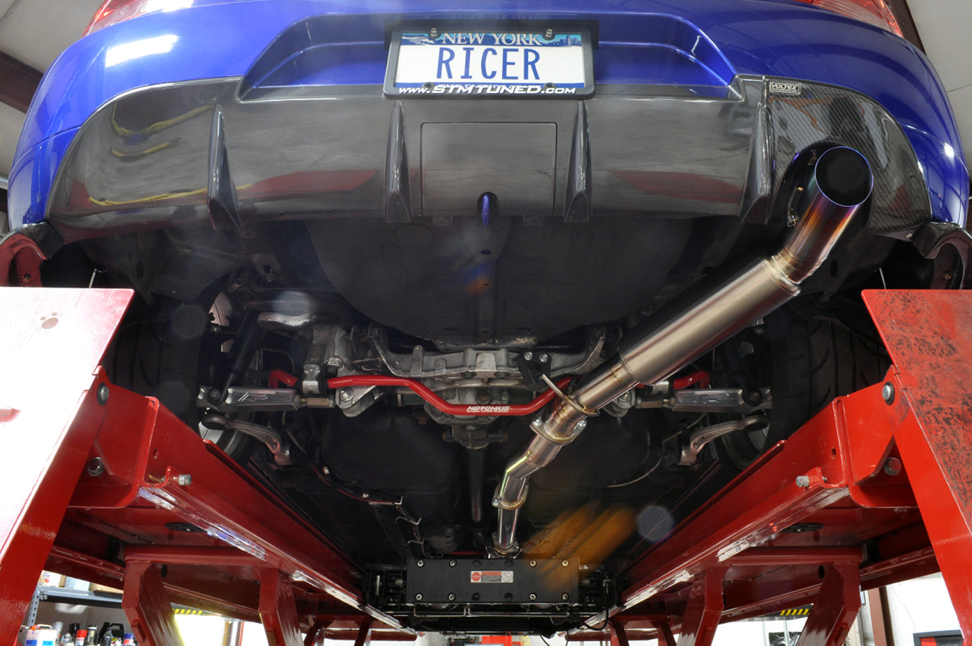 STM Titanium CatBack Exhaust Installed on a 2005 Electric Blue Evo 8 with JDM 9 Rear Bumper